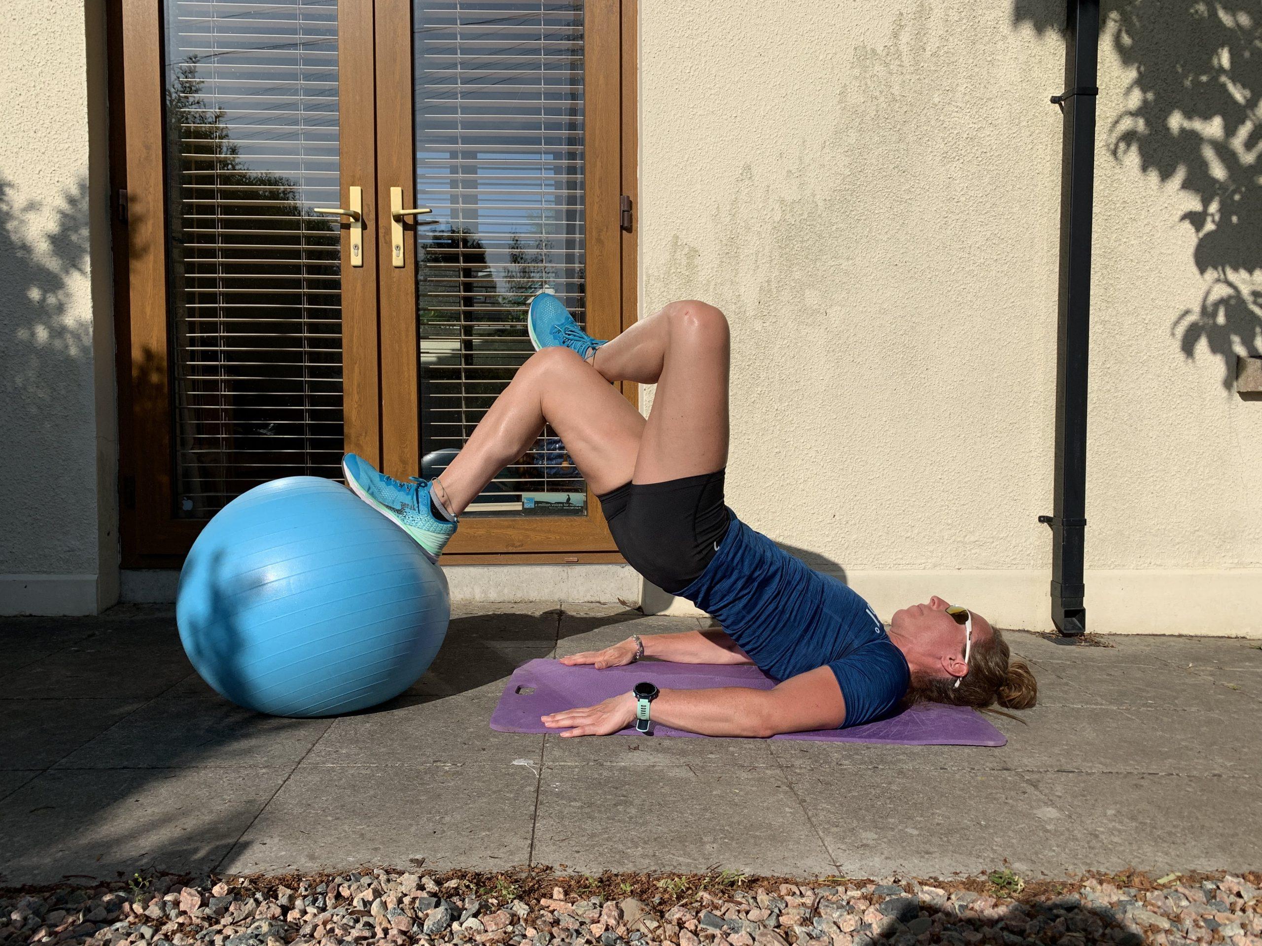 Hamstring curls exercise using a swiss ball